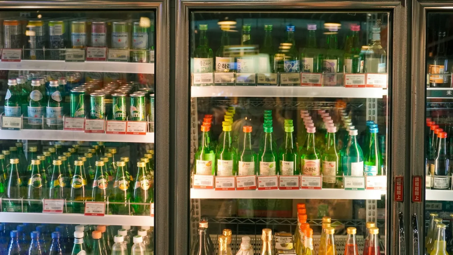 Convenience Store Funding 7 Glass-door drink coolers stocked with beverages in a convenience store