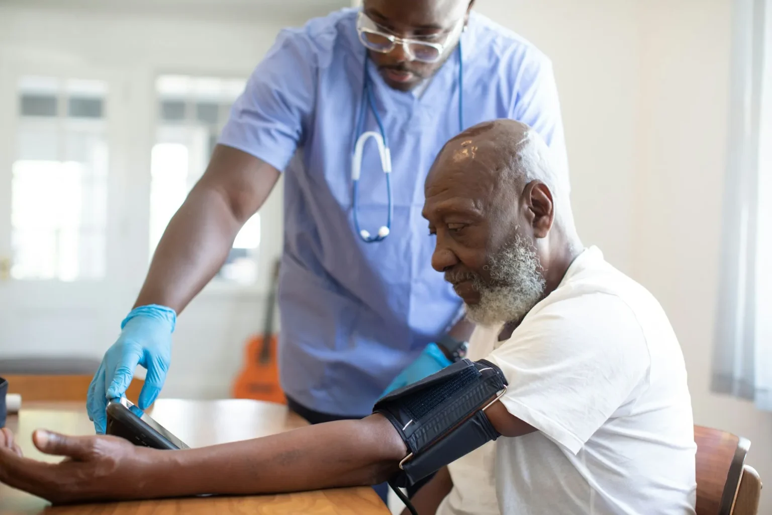 Home Health Care Funding 7 Home health nurse checking an older man’s blood pressure during a home visit
