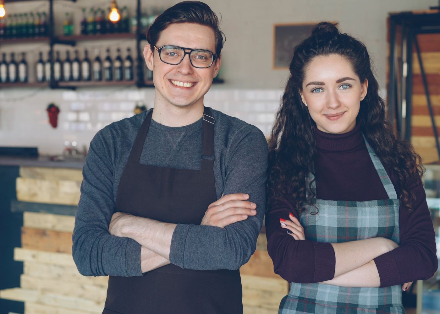 Two small business owners standing together in their shop