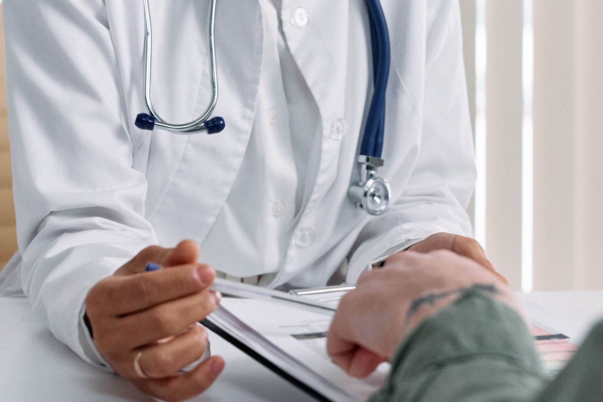 Physician reviewing notes on a clipboard in a clinic