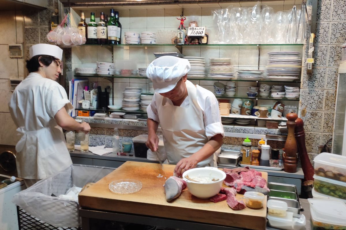 Chef plating a dish in a restaurant kitchen