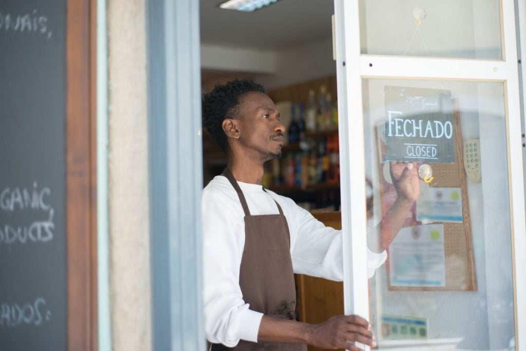 Shop owner serving a customer at the counter