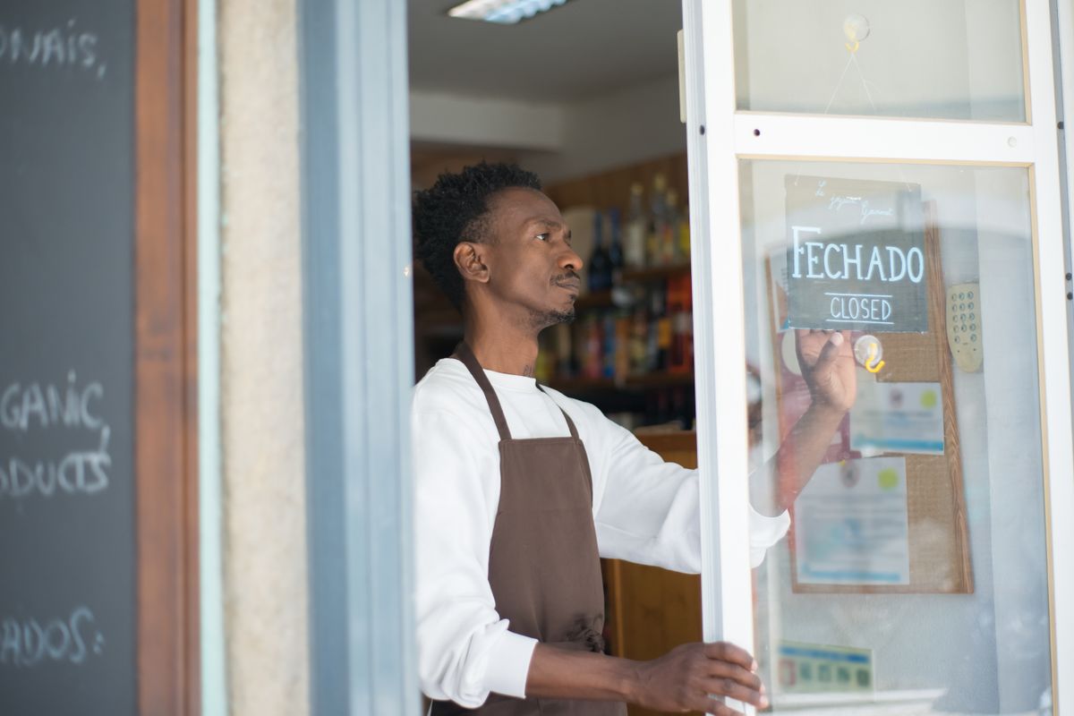 Q4 Business Loans: Get Funded Before the Holiday Rush (2026) 2 Retail shop owner arranging products on shelves before the holiday season