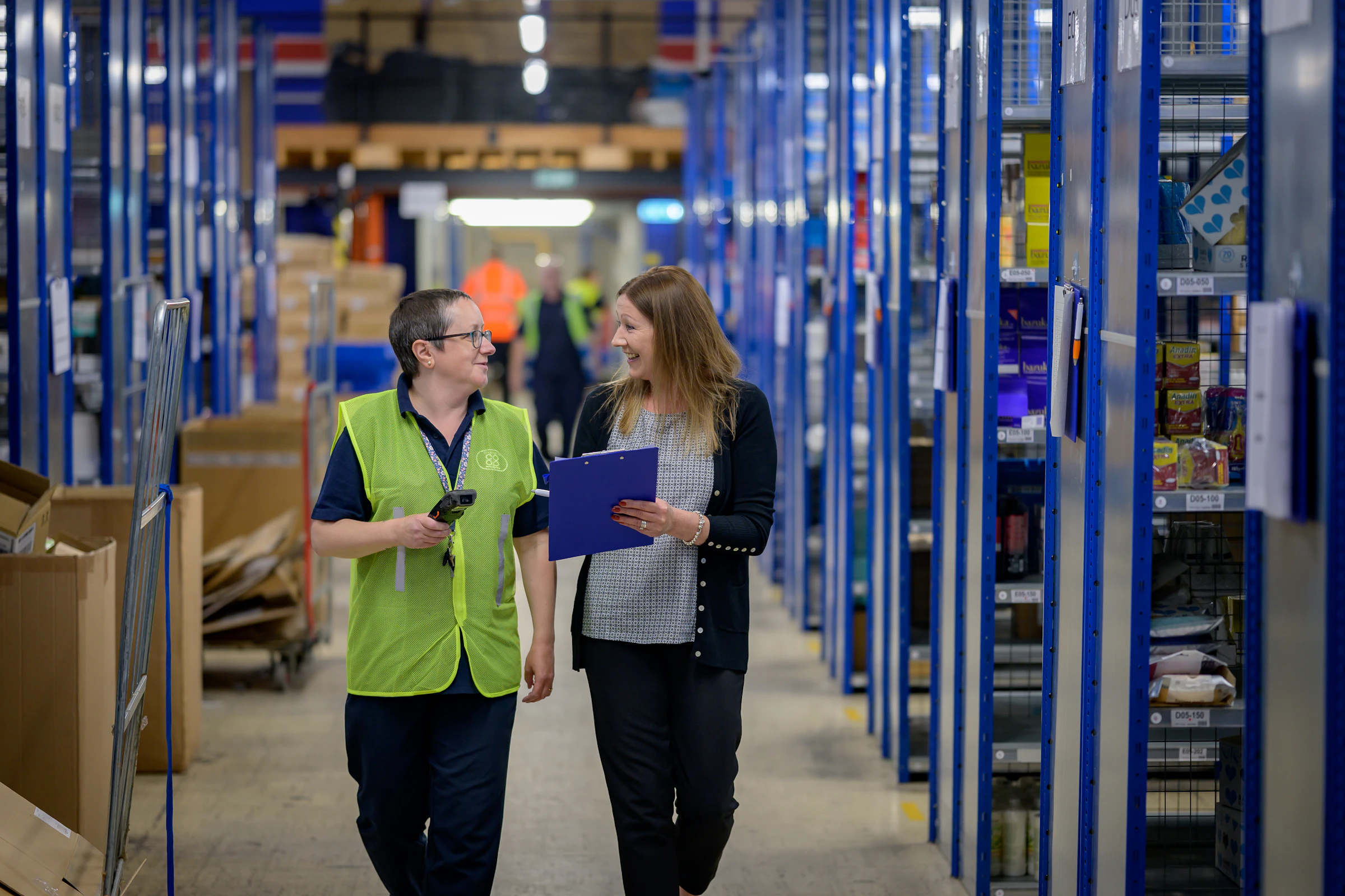 How to Get a $1 Million Business Loan: Requirements, Timeline and Options 2 Two warehouse managers reviewing inventory in a distribution center funded with a $1 million business loan