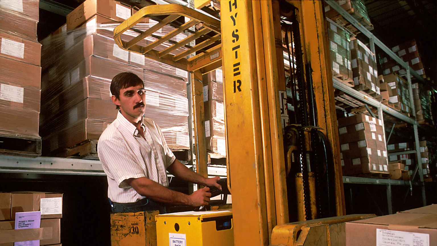 Wholesale & Distribution Funding 7 Distributor employee driving a forklift loaded with palletized inventory