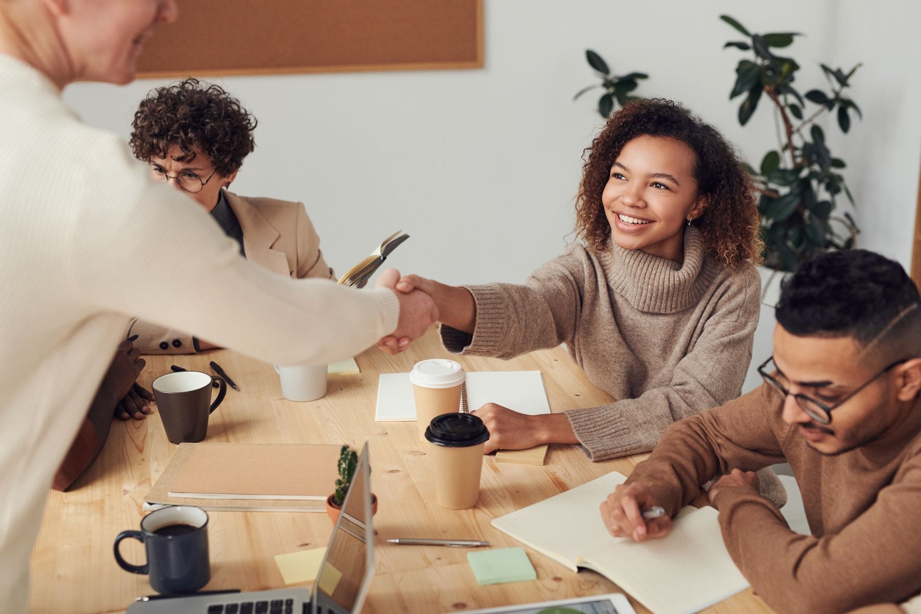 $100K Business Line of Credit: What It Takes to Qualify and What It Costs (2026) 2 Business team reviewing financial figures on laptops and printouts