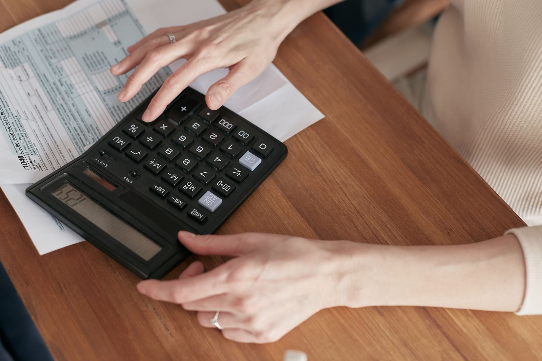 $10,000 Business Loan: Fastest Ways to Get $10K, What It Costs and Who Qualifies (2026) 2 Calculating a small business loan payment on a calculator