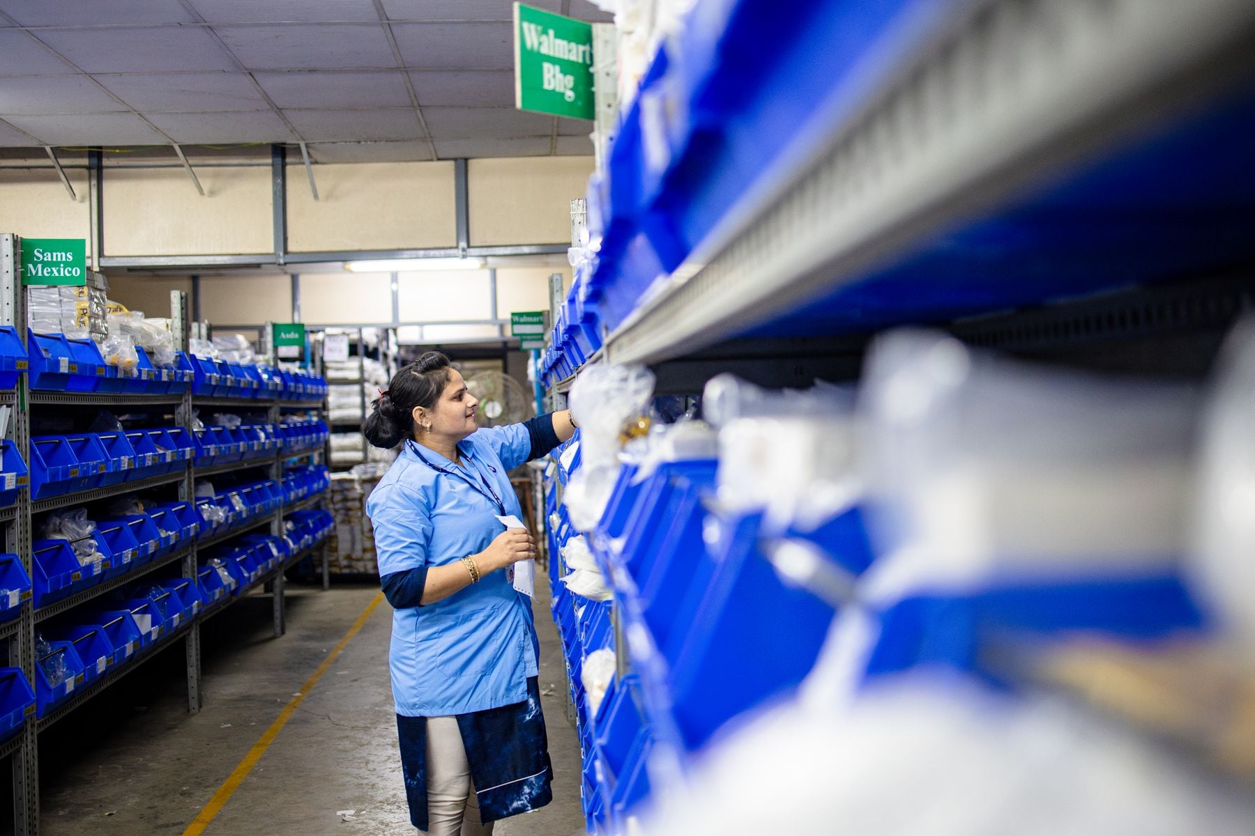 How Hard Is It to Get a $300,000 Business Loan? 2 Warehouse worker checking inventory on stock shelves