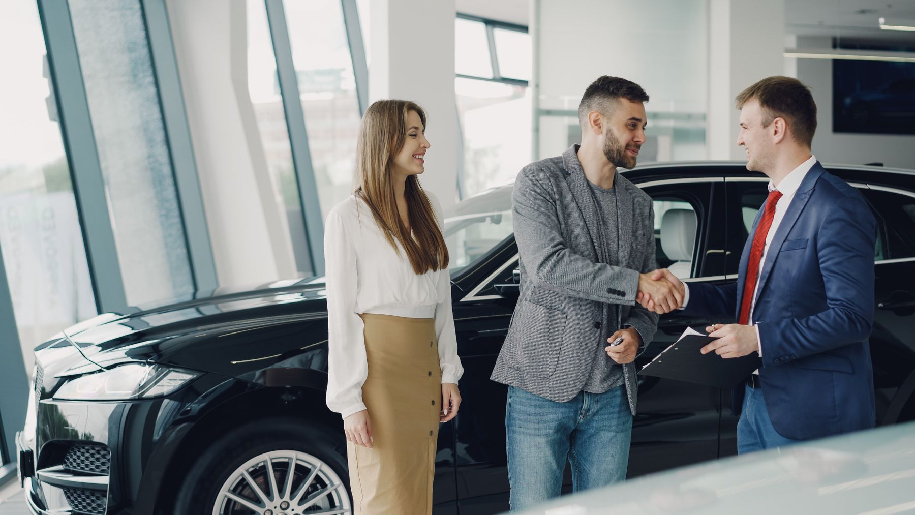 Equipment Financing With Bad Credit: How to Get Approved in 2026 2 Customers shaking hands with a dealer in a showroom