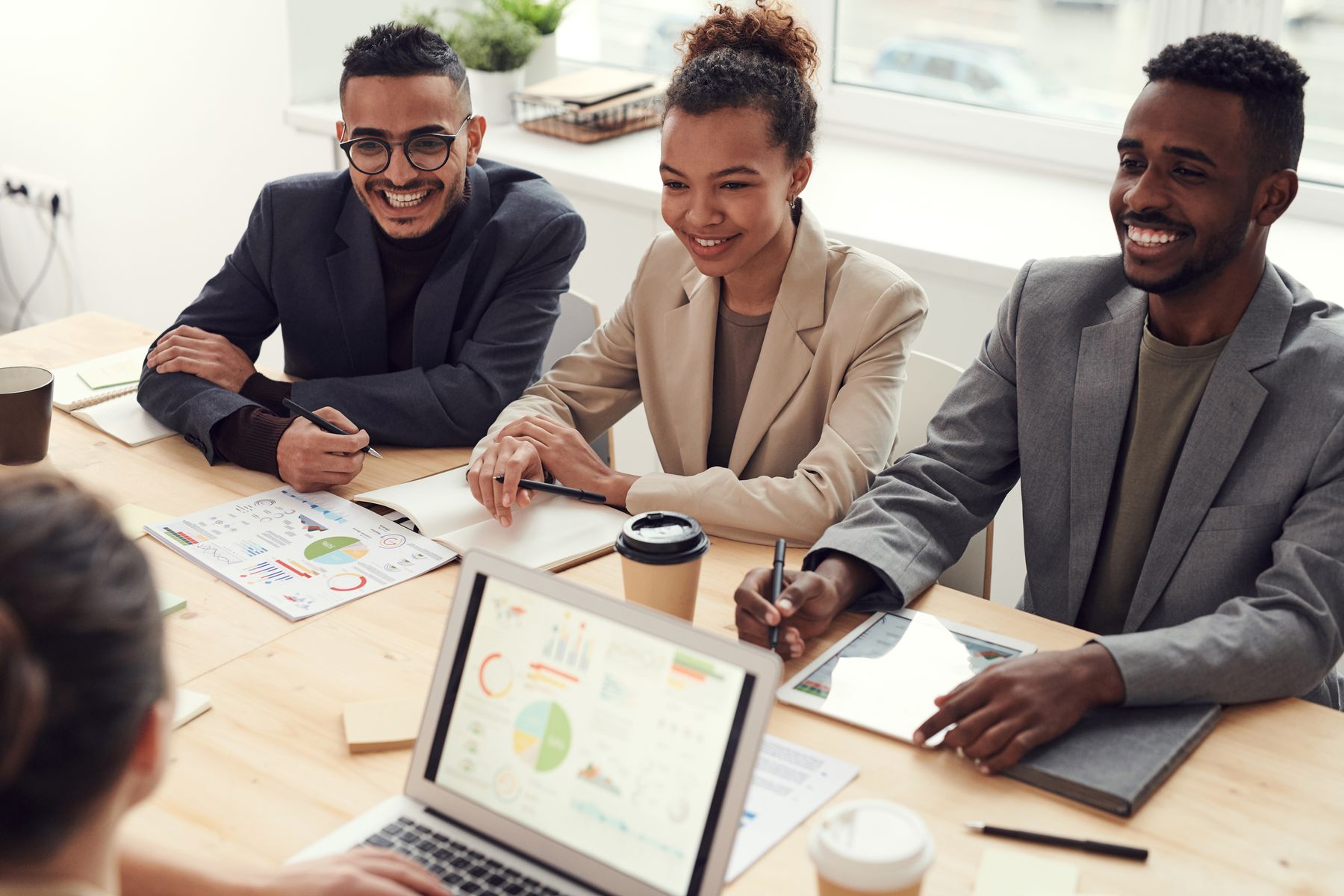 Best Business Funding Companies in 2026: 6 Options Compared 2 Business owners comparing financing offers around a conference table