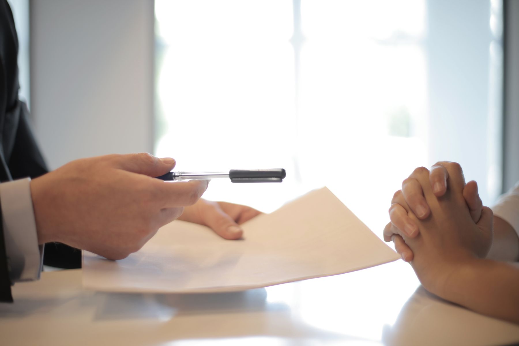 Best Invoice Factoring Companies of October 2026: 7 Options Compared on Rates, Advance and Terms 2 Handing invoices across a desk for financing