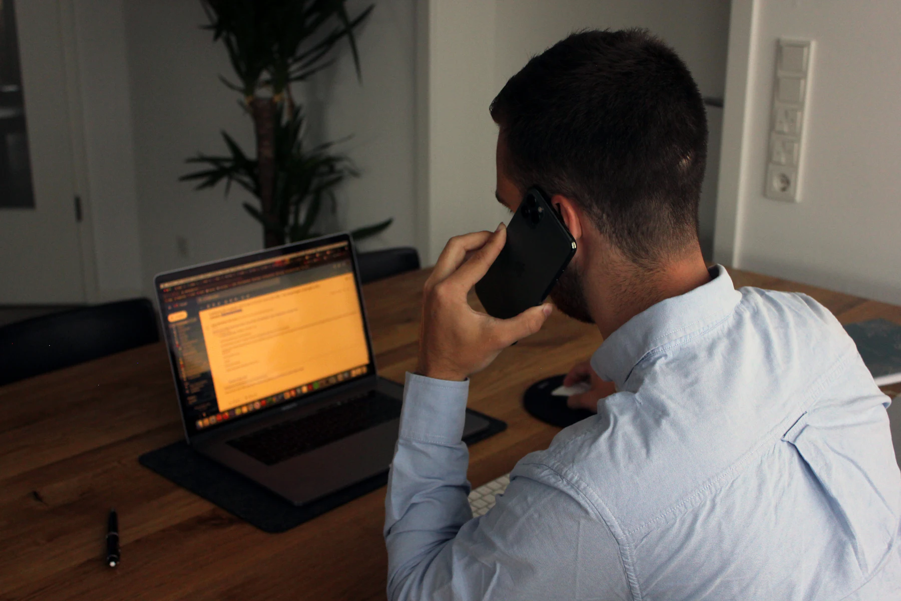 Best Same-Day Business Loans in 2026: 5 Options 2 Business owner on a phone call at a desk with a laptop