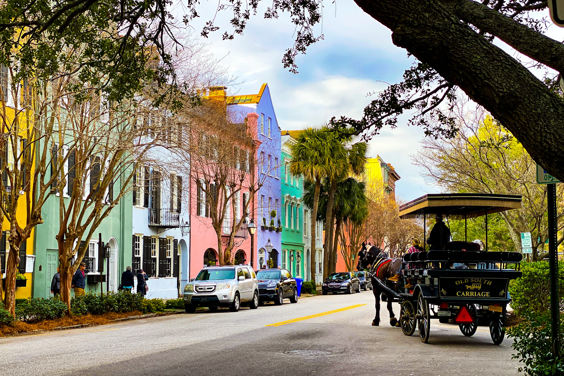 People riding in a carriage along a street in Charleston