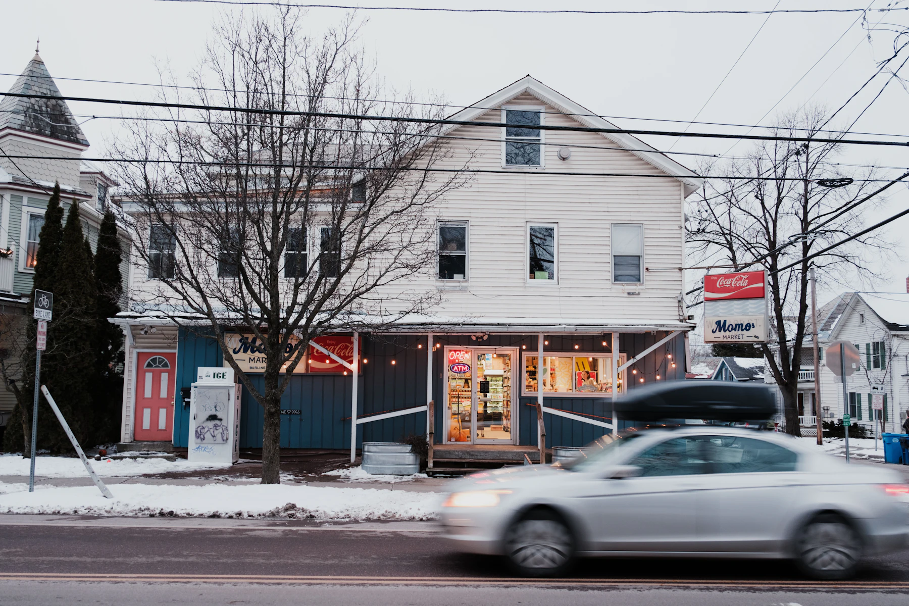 5 Reasons Vermont Business Owners Get Business Financing in 2026 2 Car driving past a white building on a Vermont town street