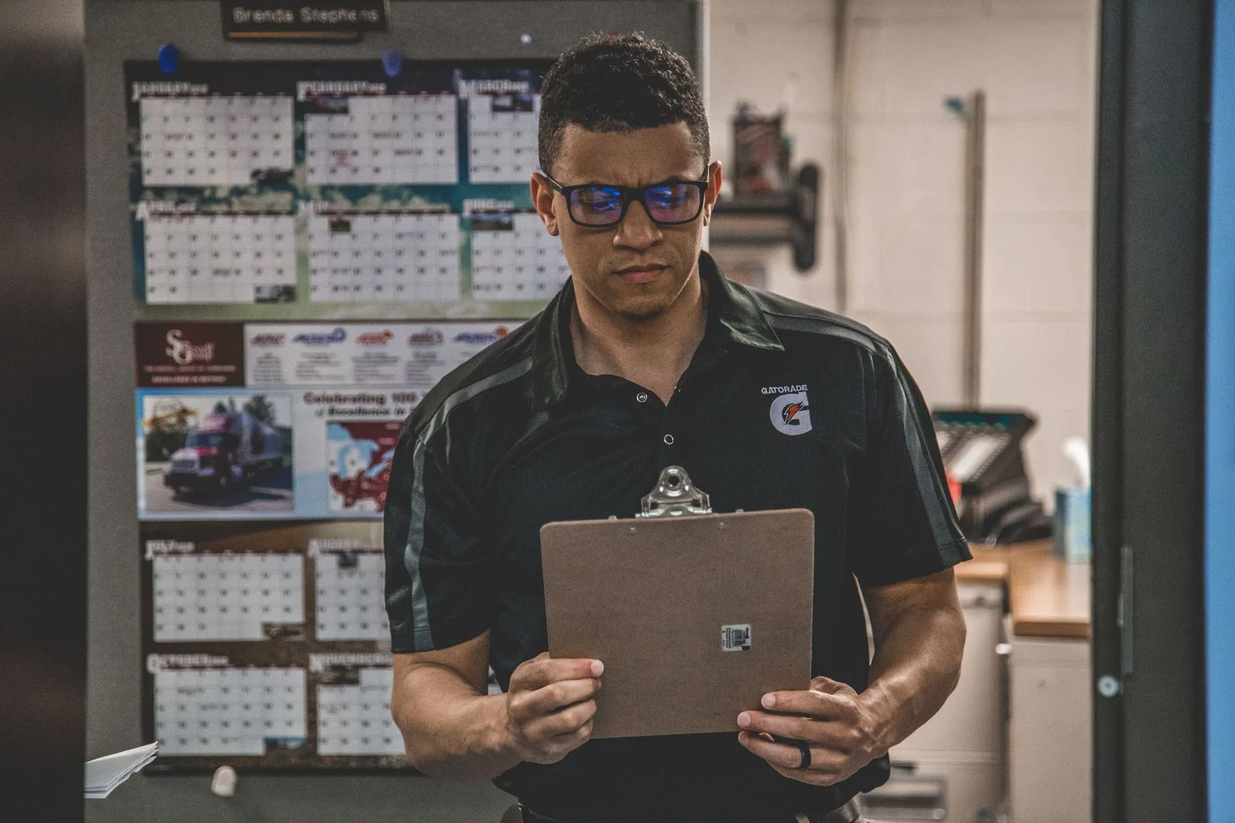 Business Funding Requirements for Established Businesses 2 Warehouse owner reviewing inventory on a clipboard between stocked shelves
