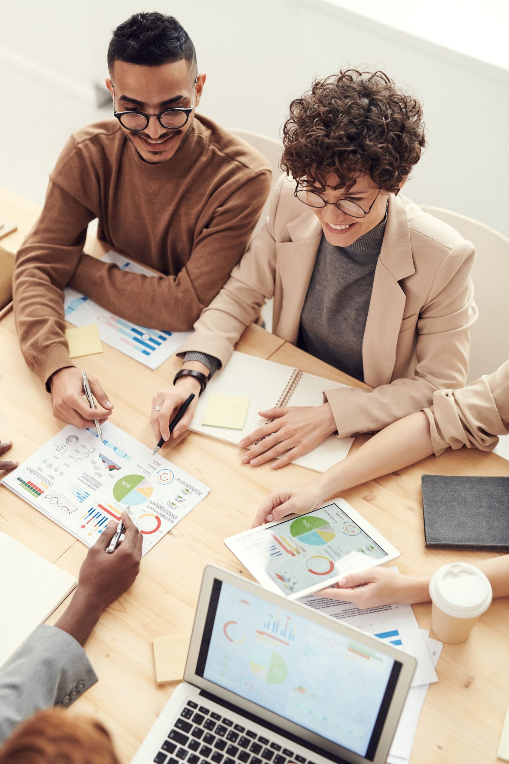 Business Line of Credit for an LLC: Requirements, Limits and How to Apply (2026) 2 LLC partners reviewing documents and plans at a work table