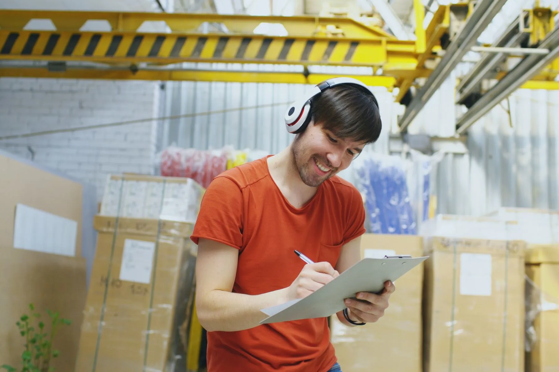 Business Line of Credit Requirements: What You Need to Qualify 2 Warehouse owner checking inventory on a clipboard between stocked shelves