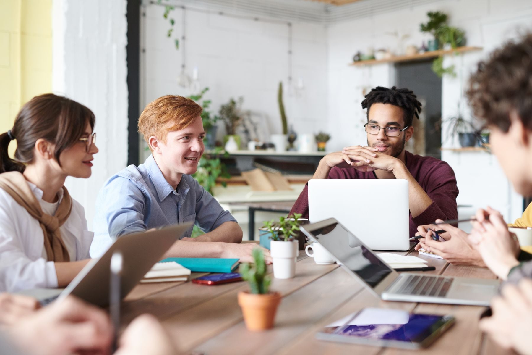 Business Line of Credit vs Business Credit Card: Which Should You Use? (2026) 2 Business owner comparing options on a laptop with colleagues