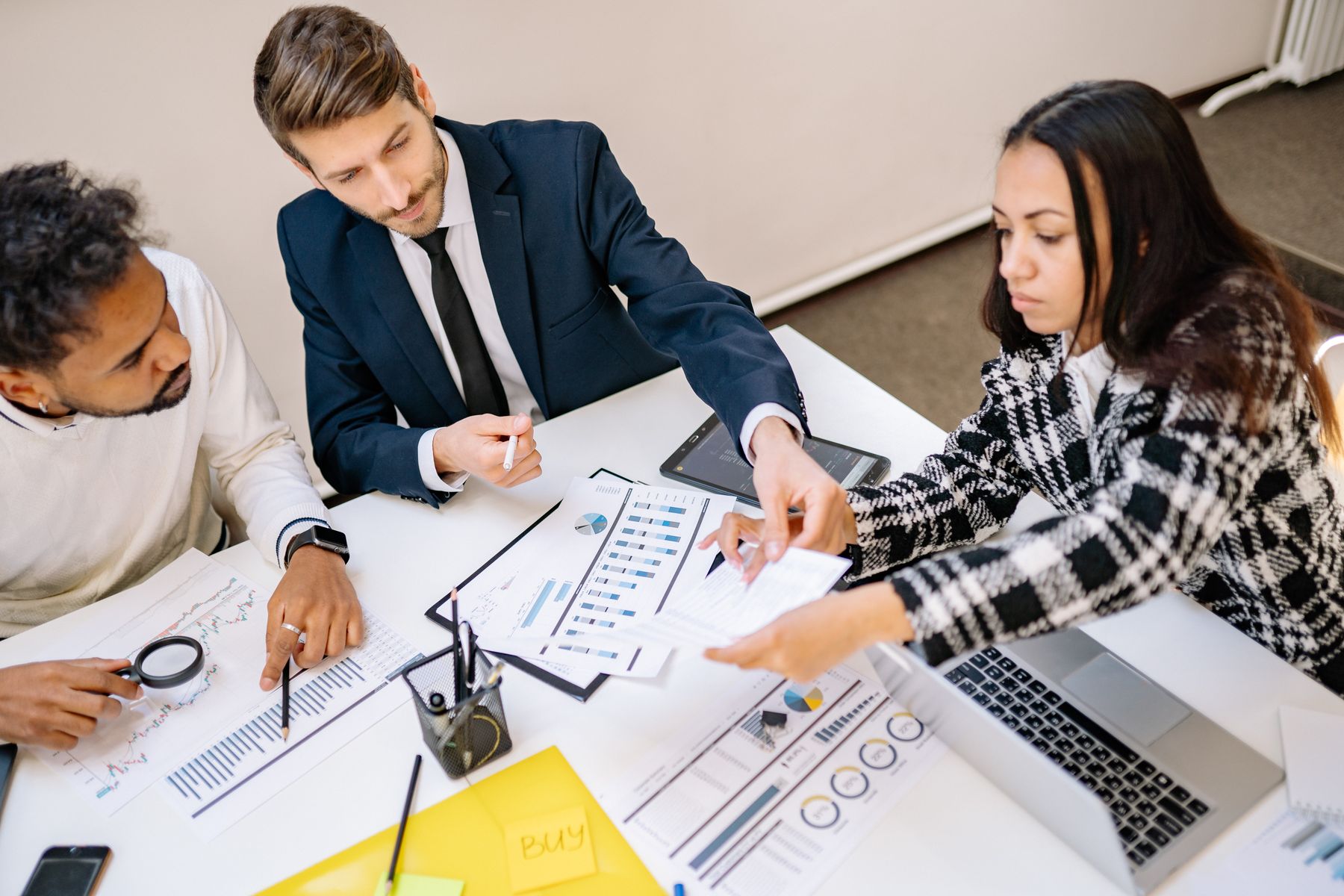 Should You Get a Business Loan or Working Capital Funding? 2 Business owner weighing options on a whiteboard in an office