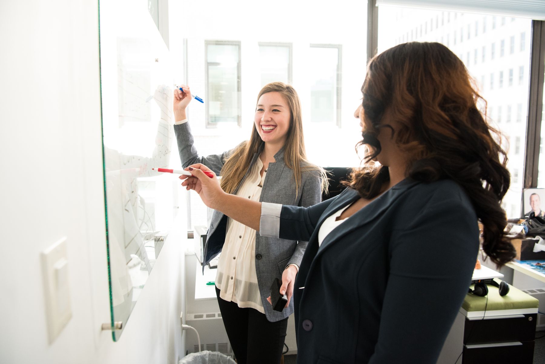 Two business partners reviewing early results in a bright office