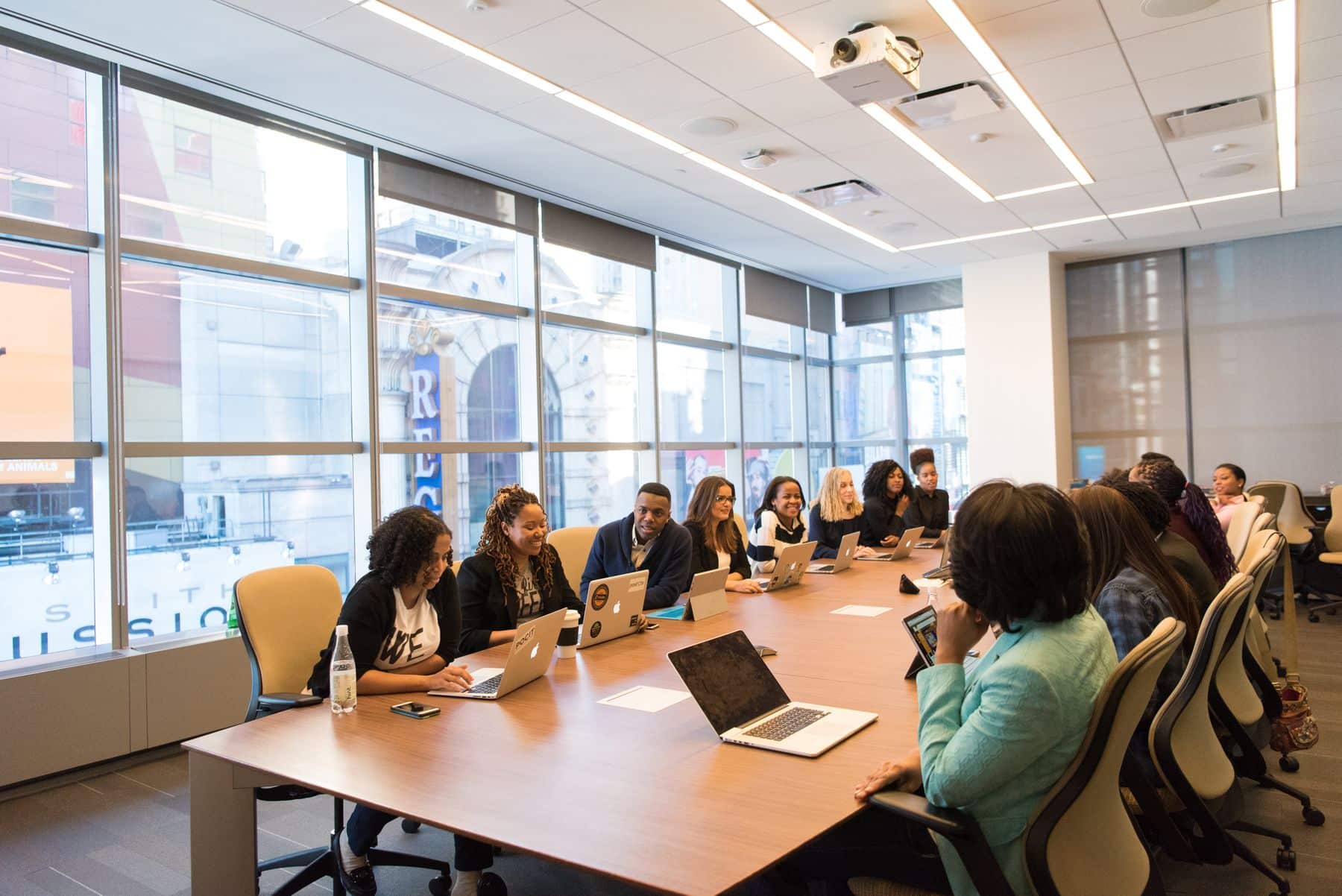 Business owners meeting around a long table in a bright office