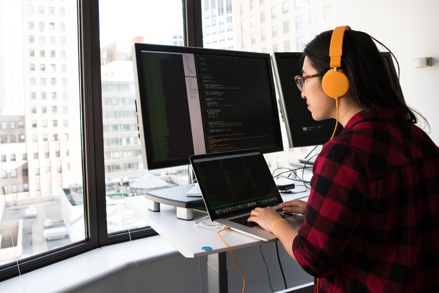 Business Loans by Amount: $10K to $5 Million, What Each Requires and Where It Comes From (2026) 2 Analyst reviewing figures on dual monitors in an office