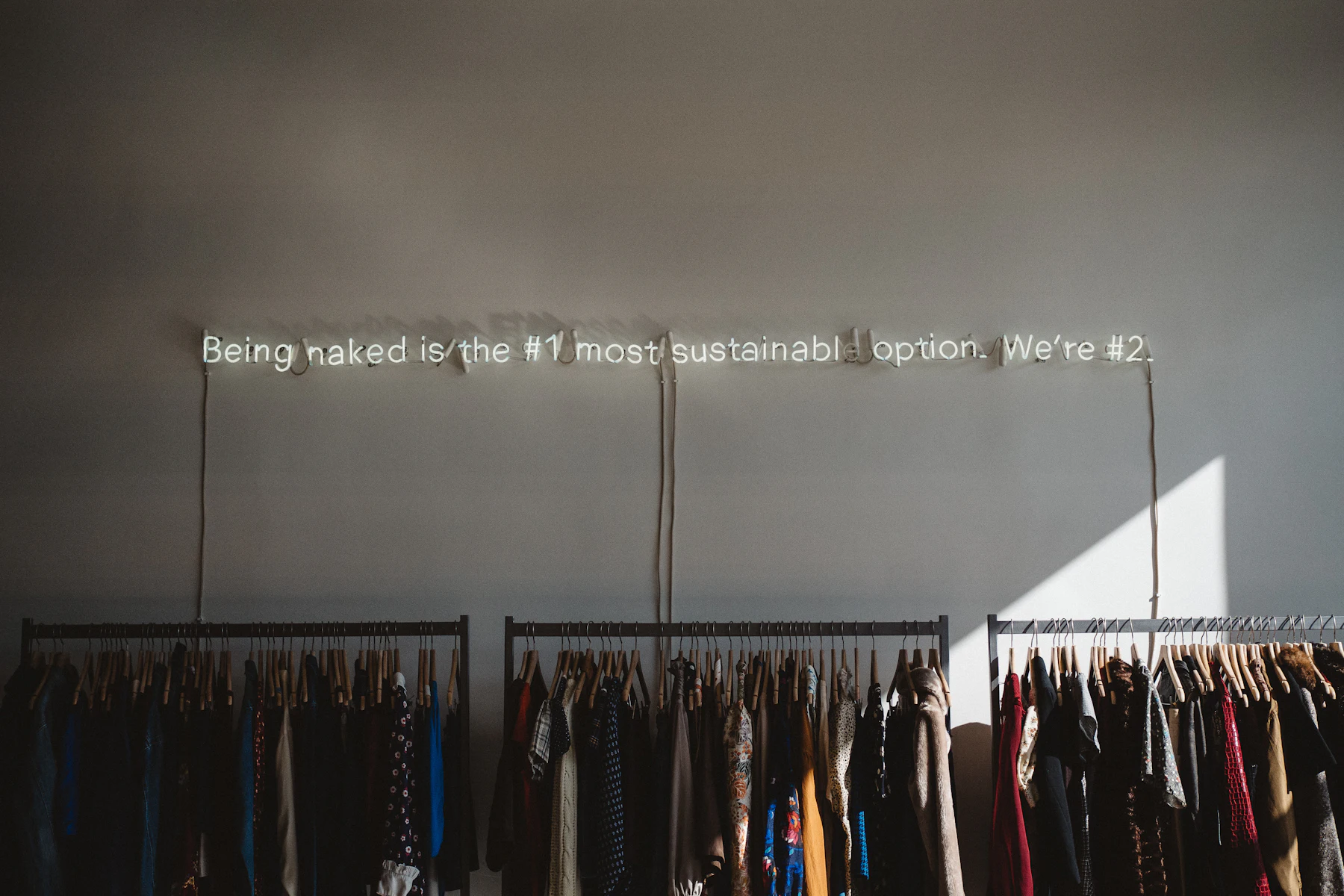 Business Loans in Los Angeles, CA: Fast Funding for Established Businesses 2 Clothes hanging on racks in a minimalist shop