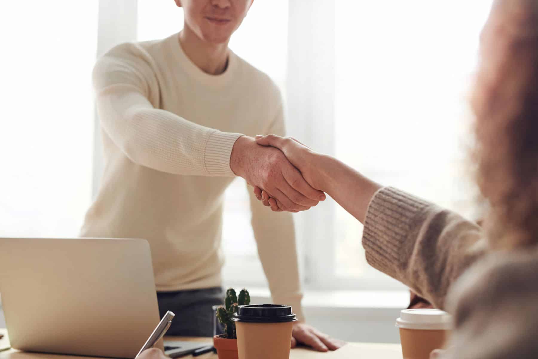 Business Loans in Miami, FL: Fast Funding Options, Rates and Requirements (2026) 2 Business owner and funding advisor shaking hands across a desk