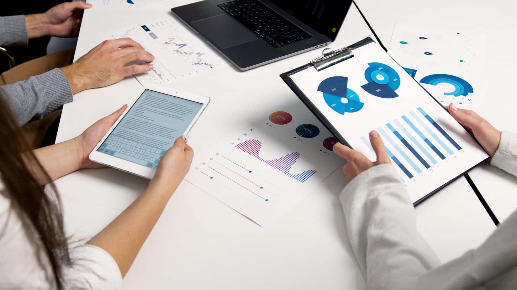 Business Term Loans in Florida: Rates, Terms, Requirements and How to Apply (October 2026) 2 Business owners reviewing charts and a tablet at a desk