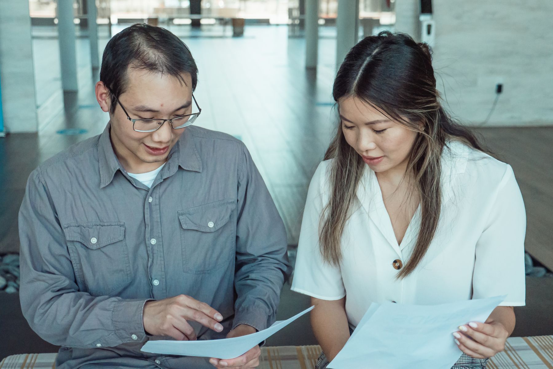 What Are Common Reasons Business Loans Get Denied? 2 Two people reviewing a business loan application together