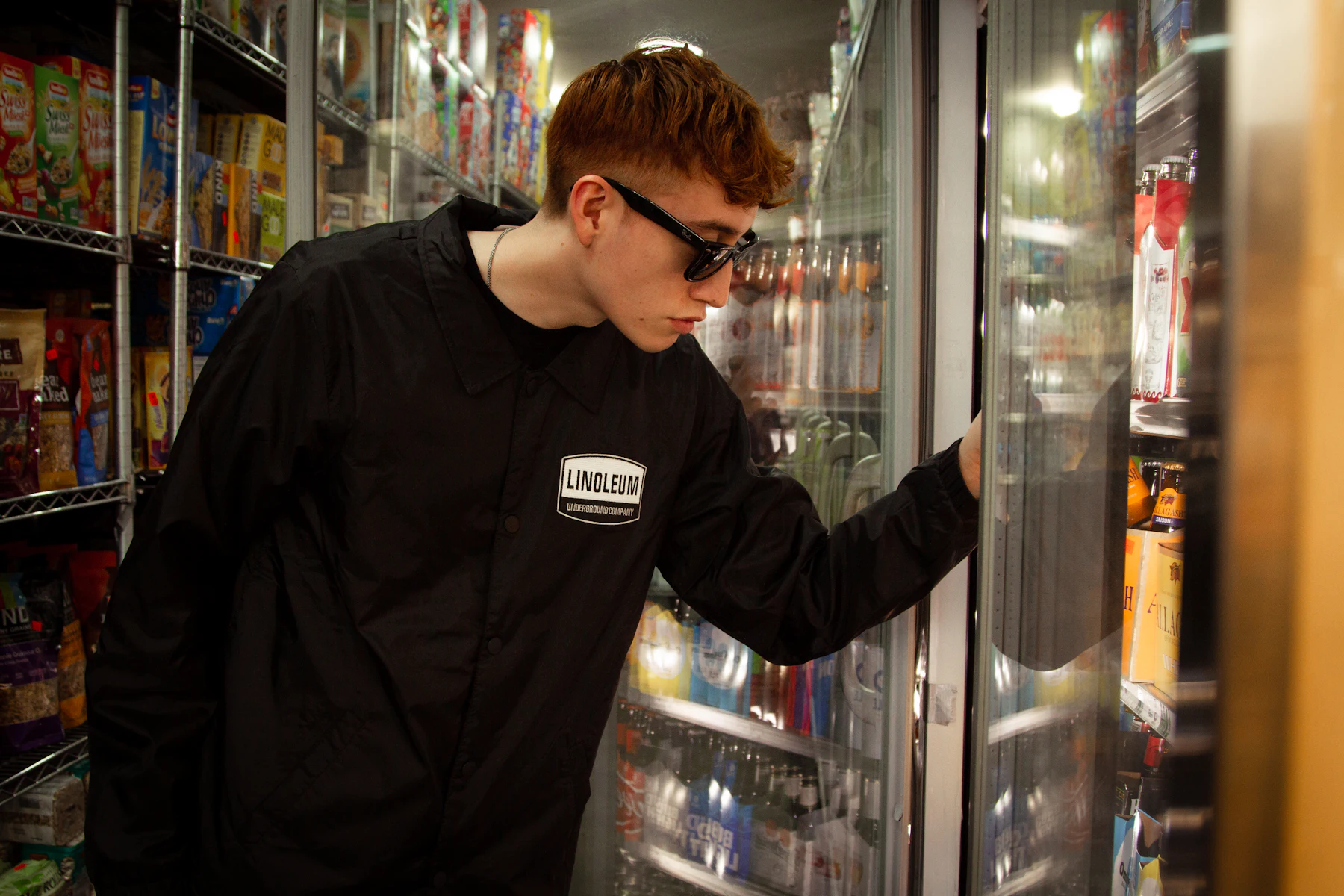 Emergency Business Loans: What to Do First and How to Get Funded Fast 2 Man in a black sweatshirt reaching into a shop cooler