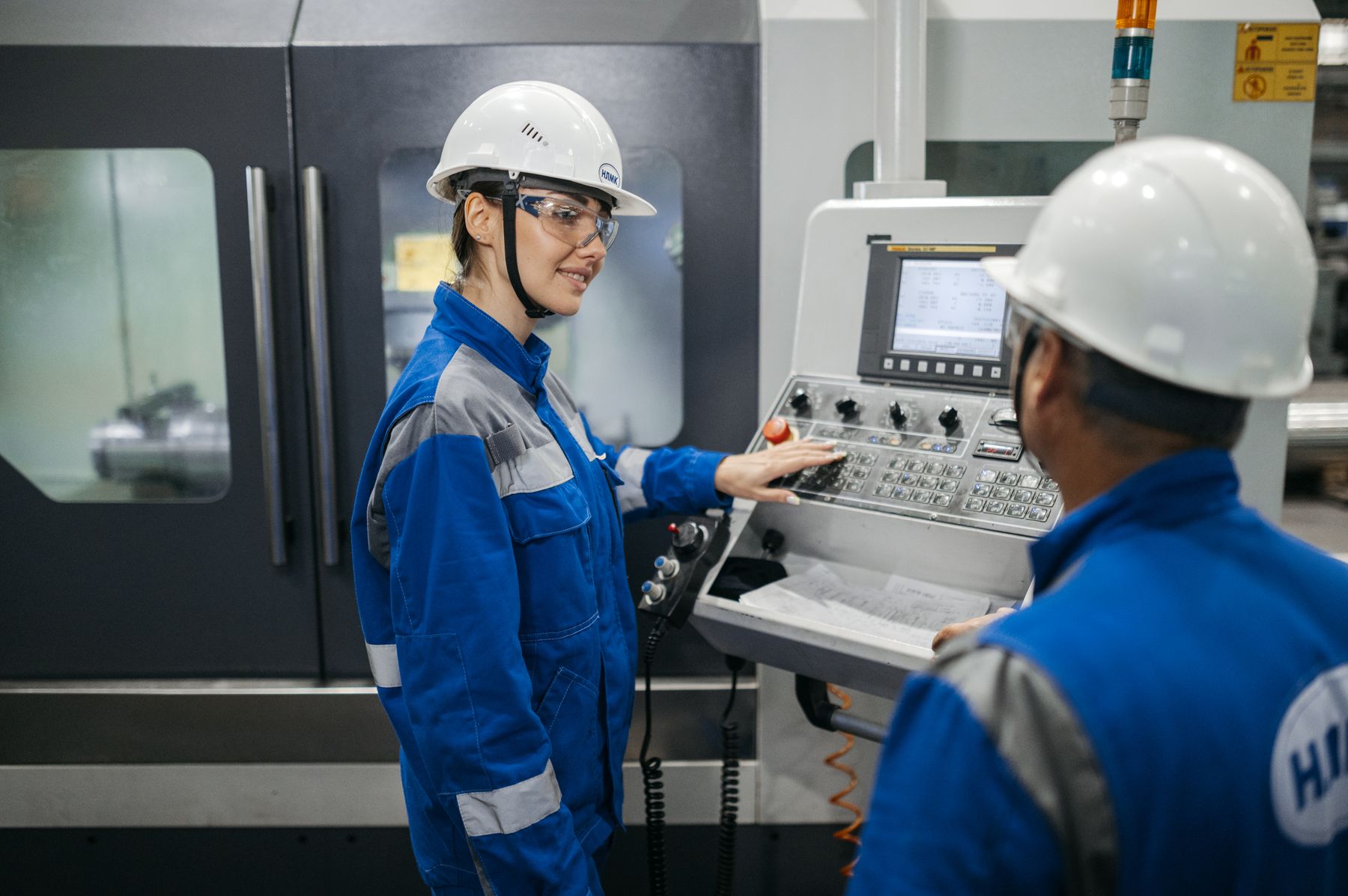 Equipment Financing Requirements: What You Need to Qualify in 2026 2 Industrial workers operating a machine on a factory floor