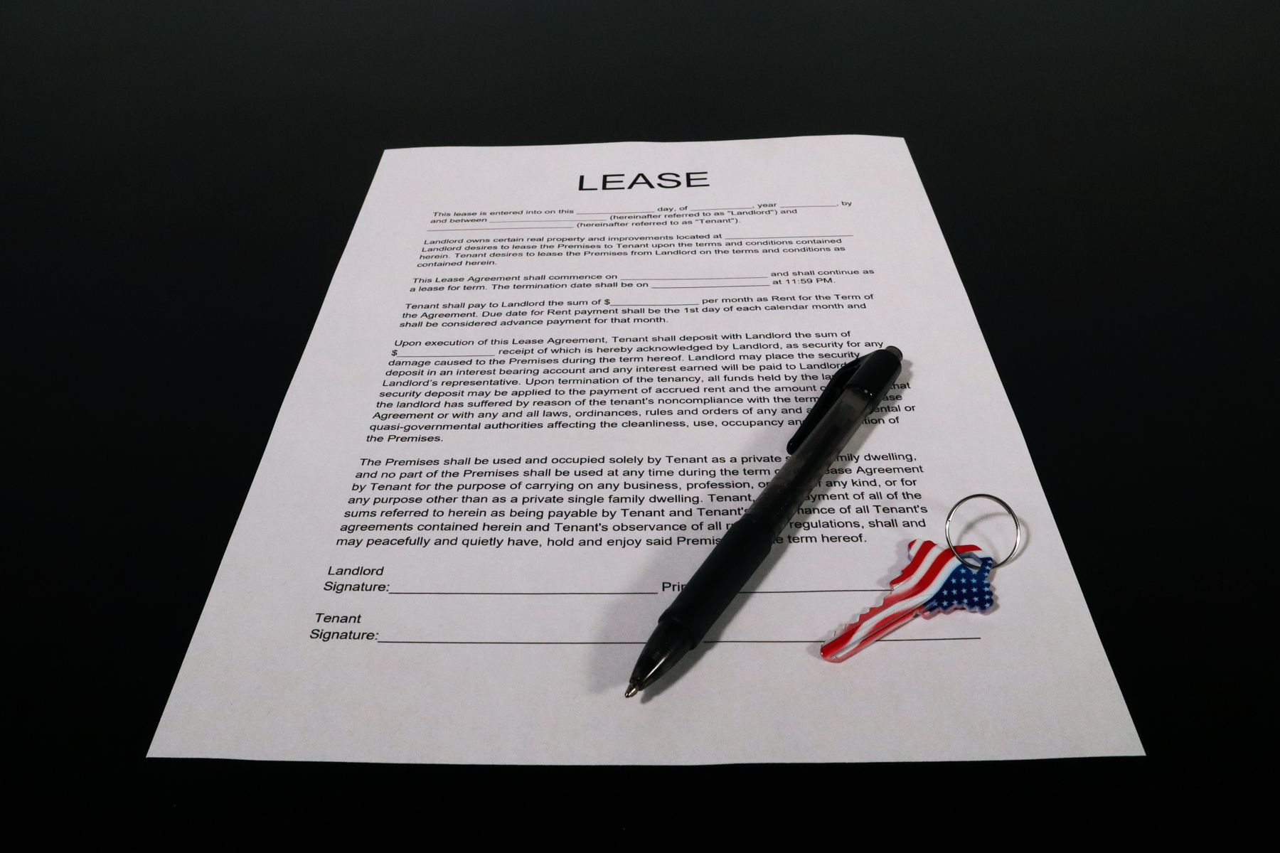 Equipment Loan vs Lease: Which Is Better for Your Business? 2 Lease agreement document with a pen on a desk
