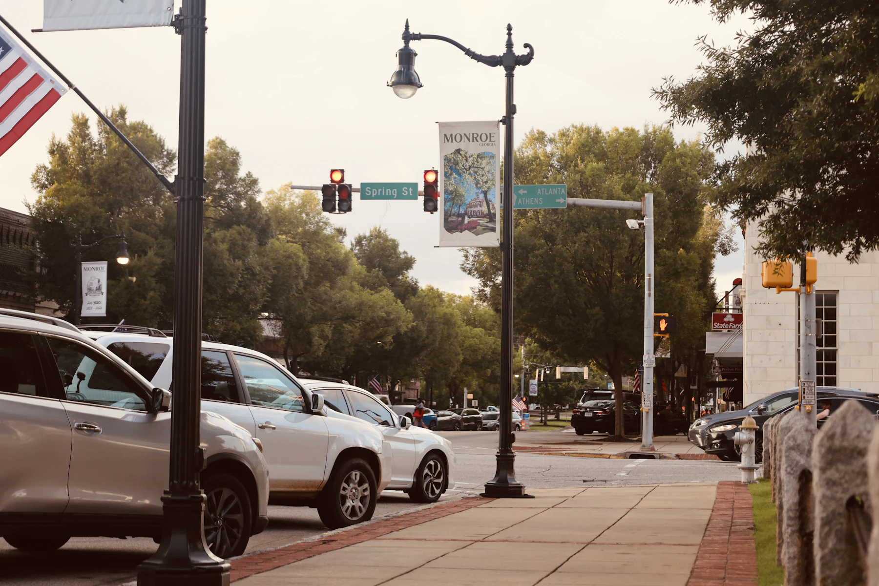 5 Razones por las que los Dueños de Negocios en Georgia Buscan Financiamiento en 2026 2 Autos estacionados en una calle con un letrero de Spring St en Monroe, Georgia