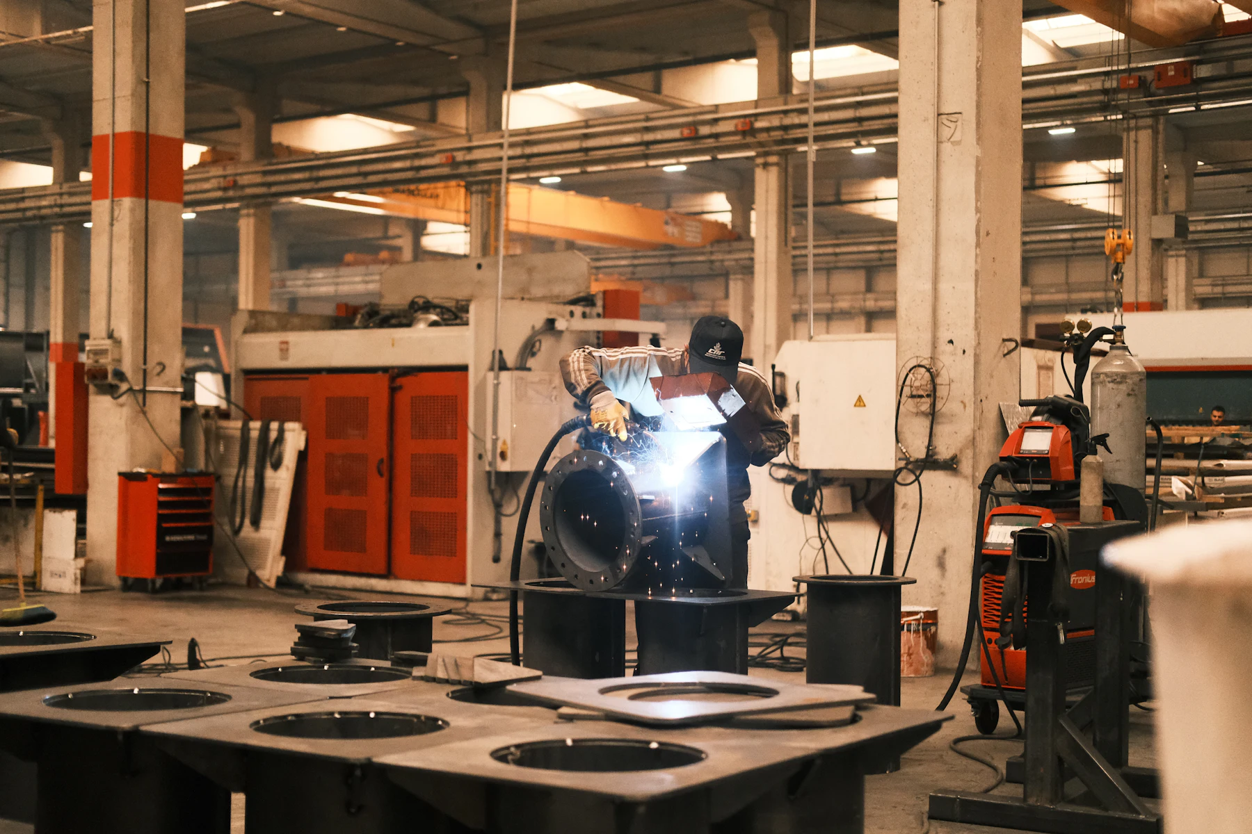 Funding for a Large Order: How to Finance Materials and Labor Before You Get Paid 2 Worker welding metal in a fabrication shop