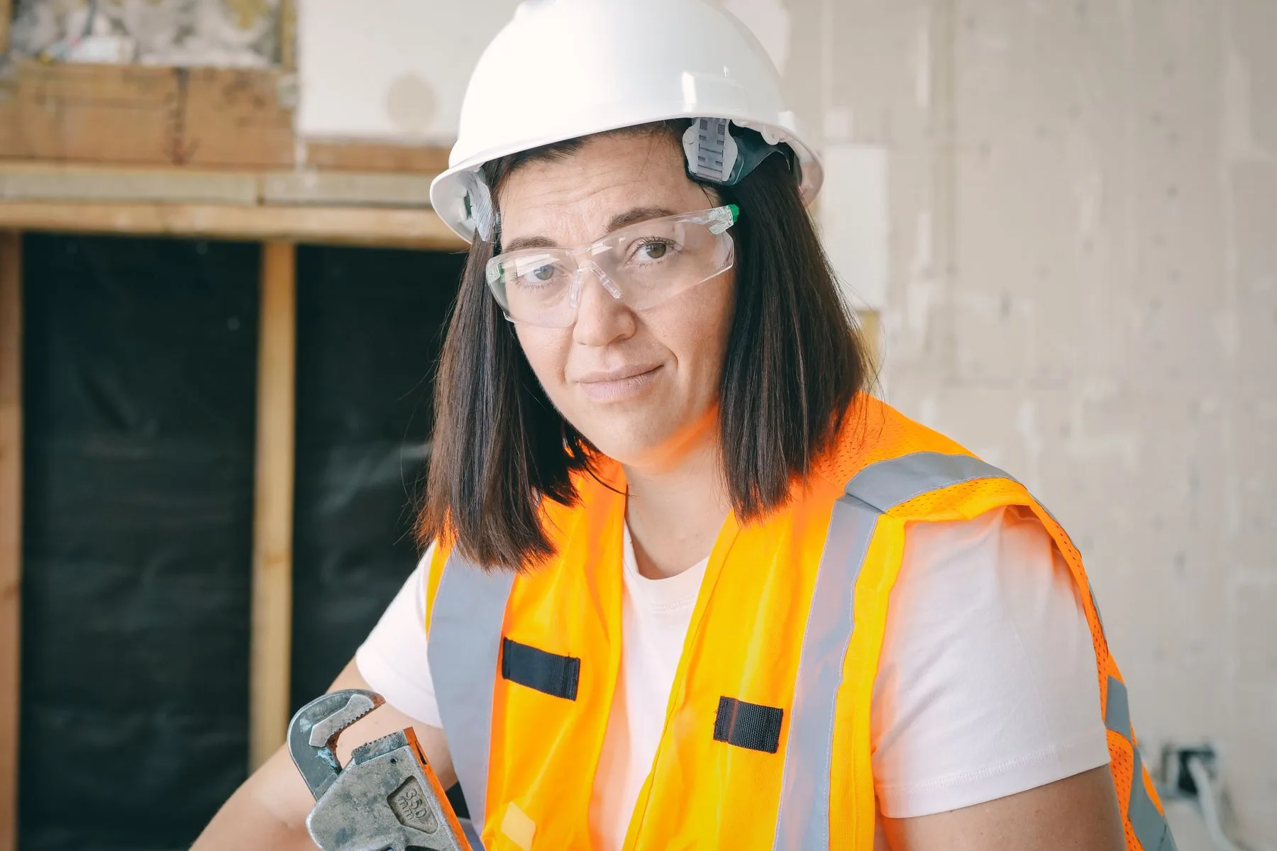 How a Business Line of Credit Works: Limit, Draws, Redraws 2 Plumber holding a pipe wrench on a job site