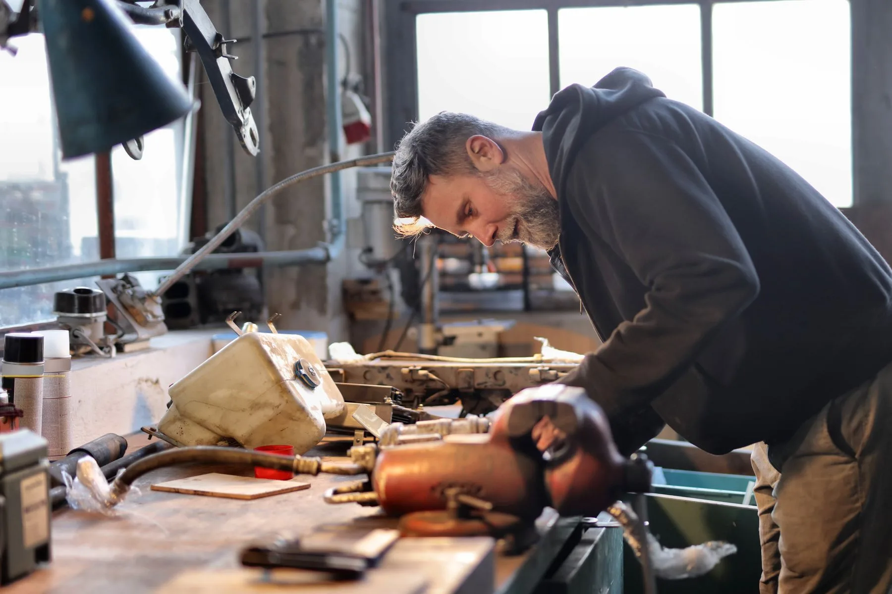 How Business Funding Works: From Application to Money in the Bank 2 Smiling auto repair shop owner at work in his garage