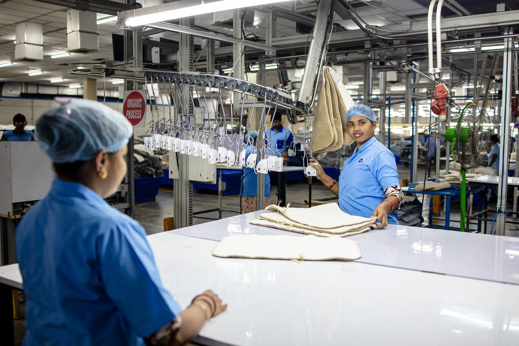 How Business Term Loans Work: Amount, Term and Timeline 2 Workers on a textile production line in a small factory