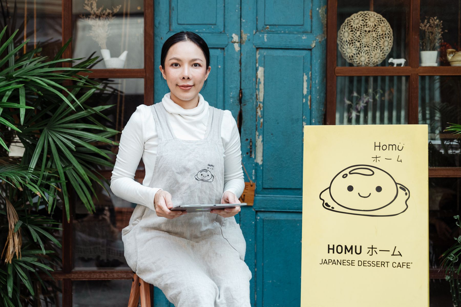 How Does Revenue-Based Financing Work? 2 Restaurant owner reviewing daily sales on a tablet