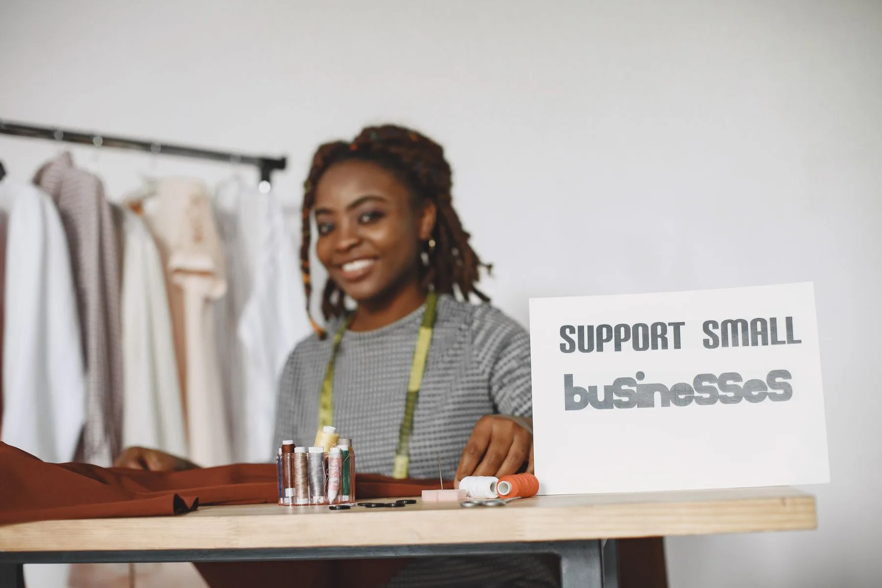 How to Compare Business Funding Companies: A 10-Point Guide 2 Small business owner smiling at her desk while reviewing paperwork