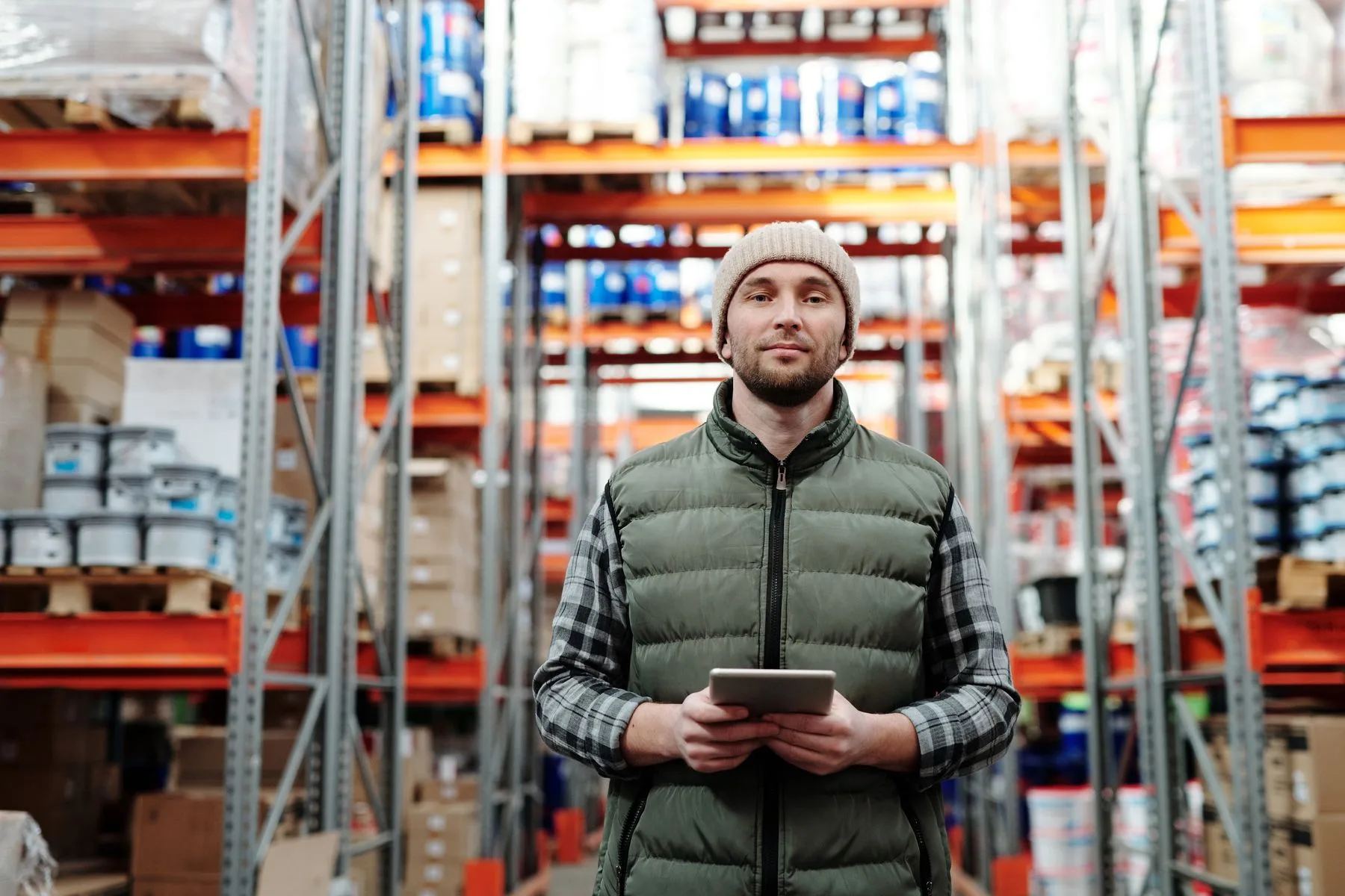 How to Compare Business Line of Credit Providers (Guide) 2 Distributor checking stock on a tablet in his warehouse