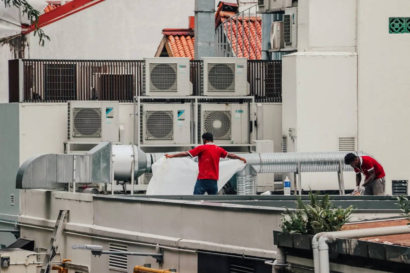 HVAC technicians servicing rooftop units for a Phoenix-area business