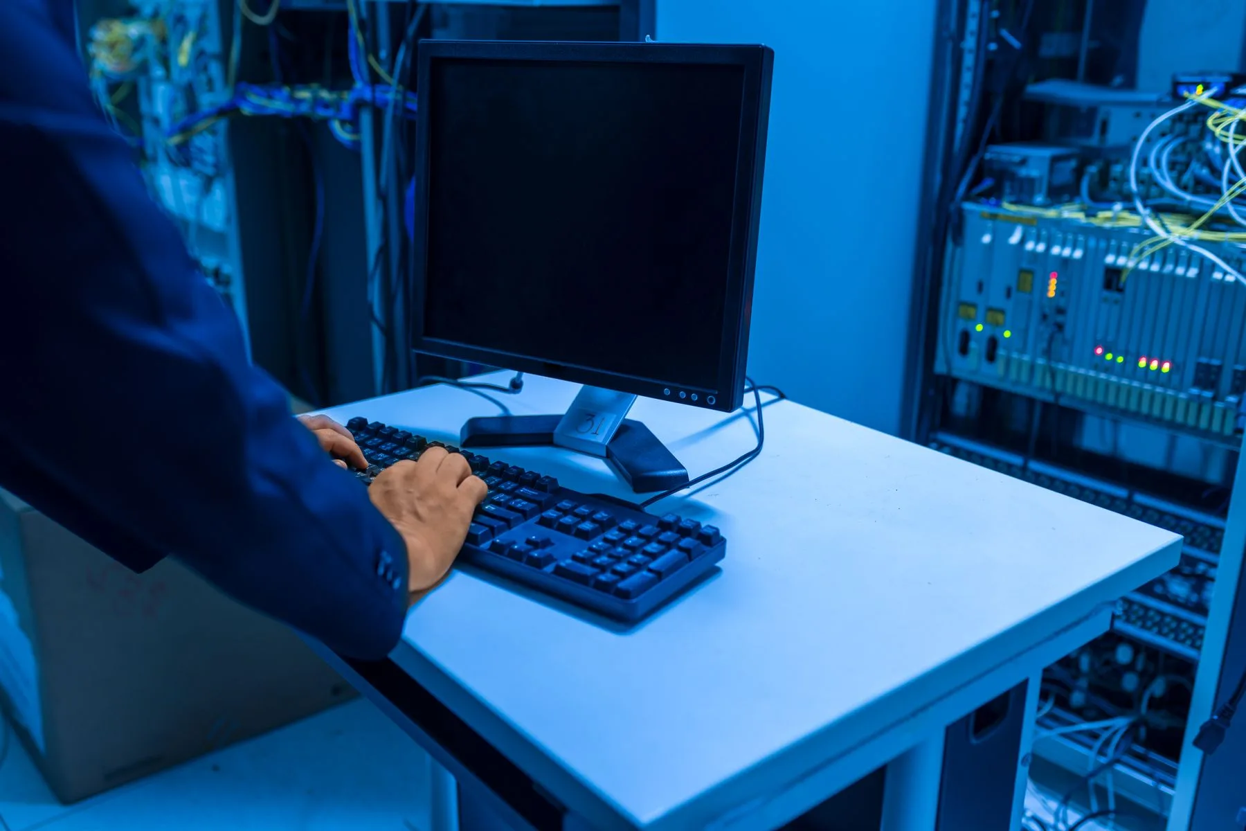 Managed IT Business Loans: Options, Requirements, Speed 2 IT technician working at a workstation in a data center server room
