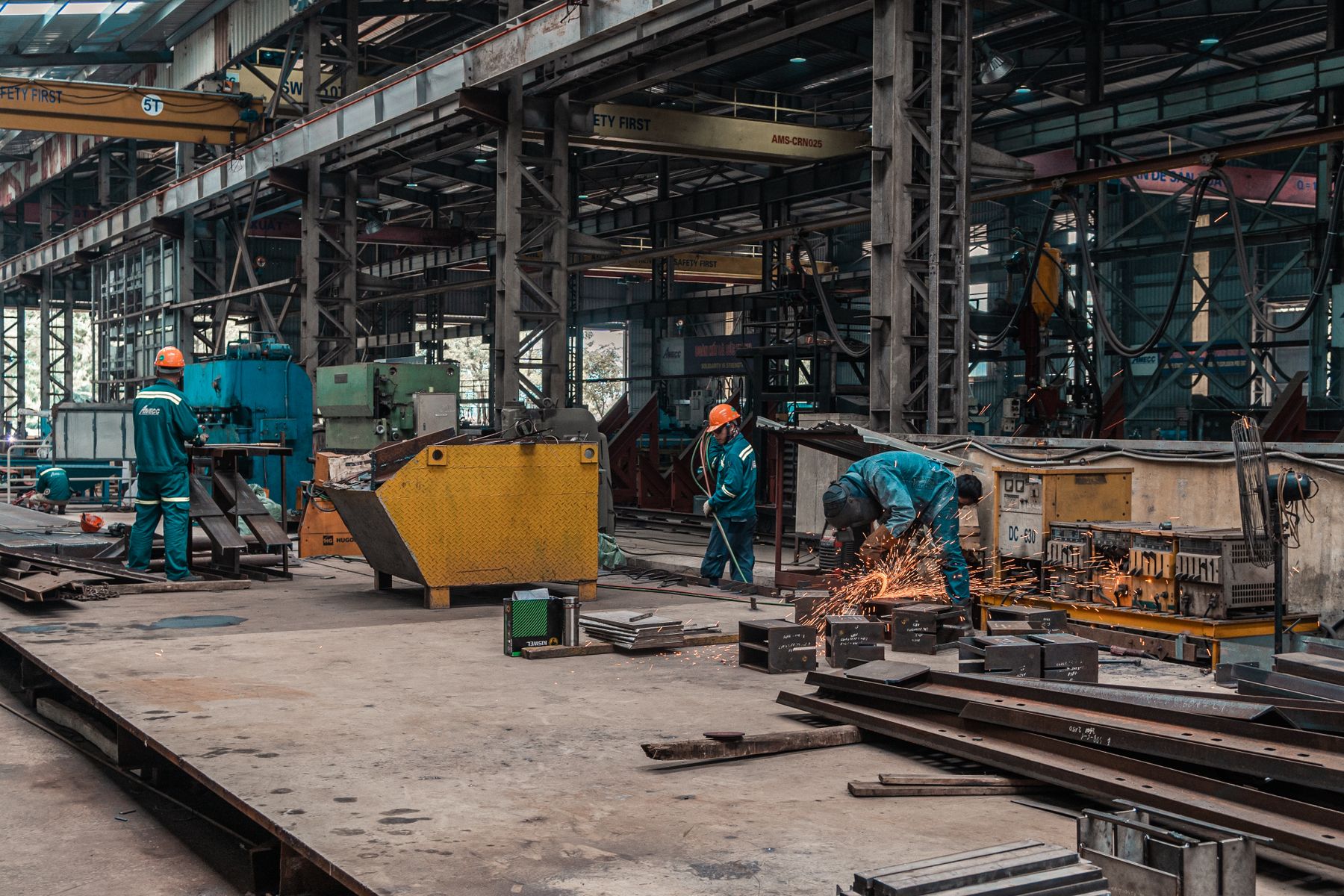 Manufacturing Working Capital Challenges: How to Fund Them 2 Workers on the floor of a metal fabrication shop