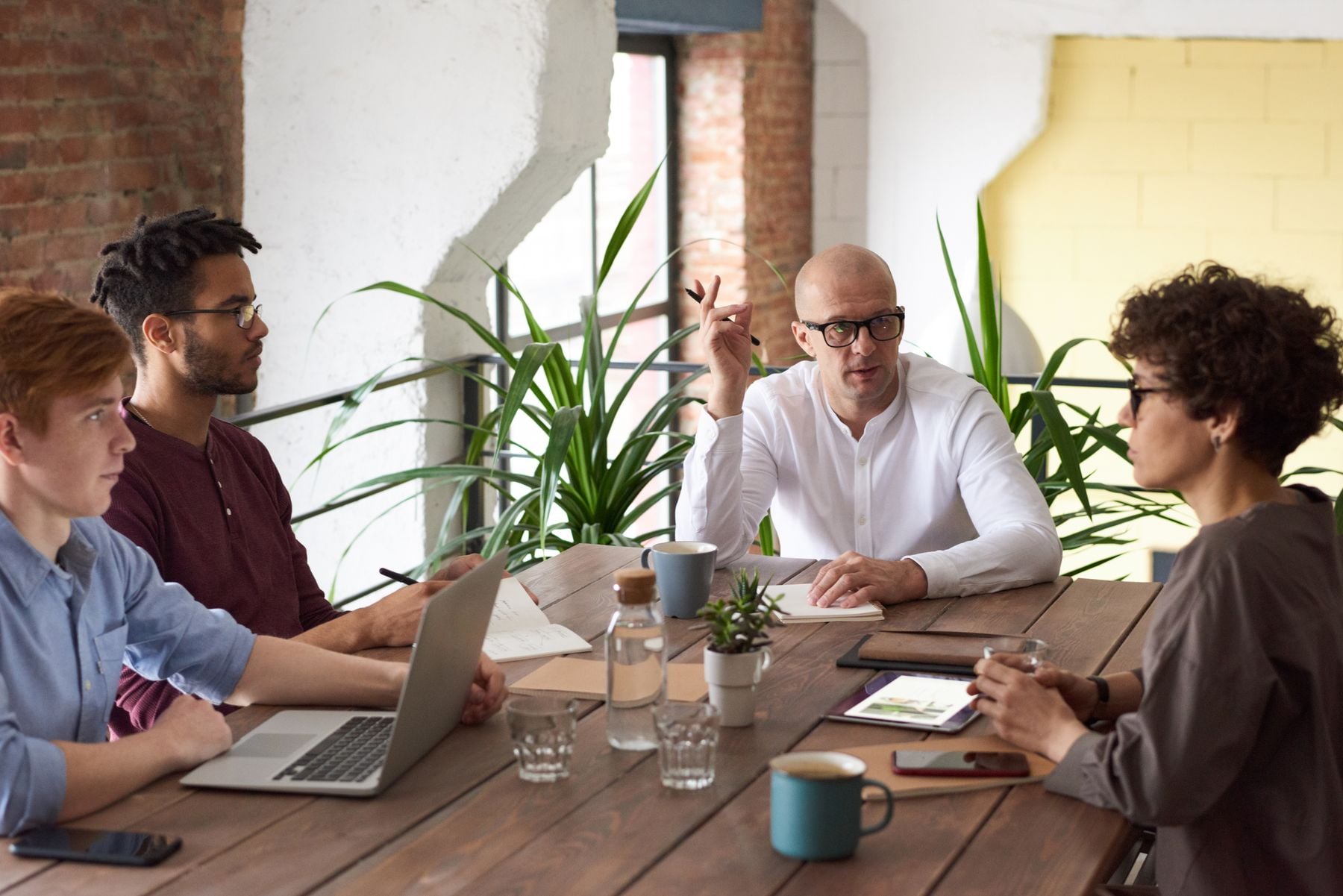 No Doc Business Loans and EIN-Only Loans: What Is Real, What It Costs and How to Qualify (2026) 2 Business owner working through paperwork at a desk with a laptop
