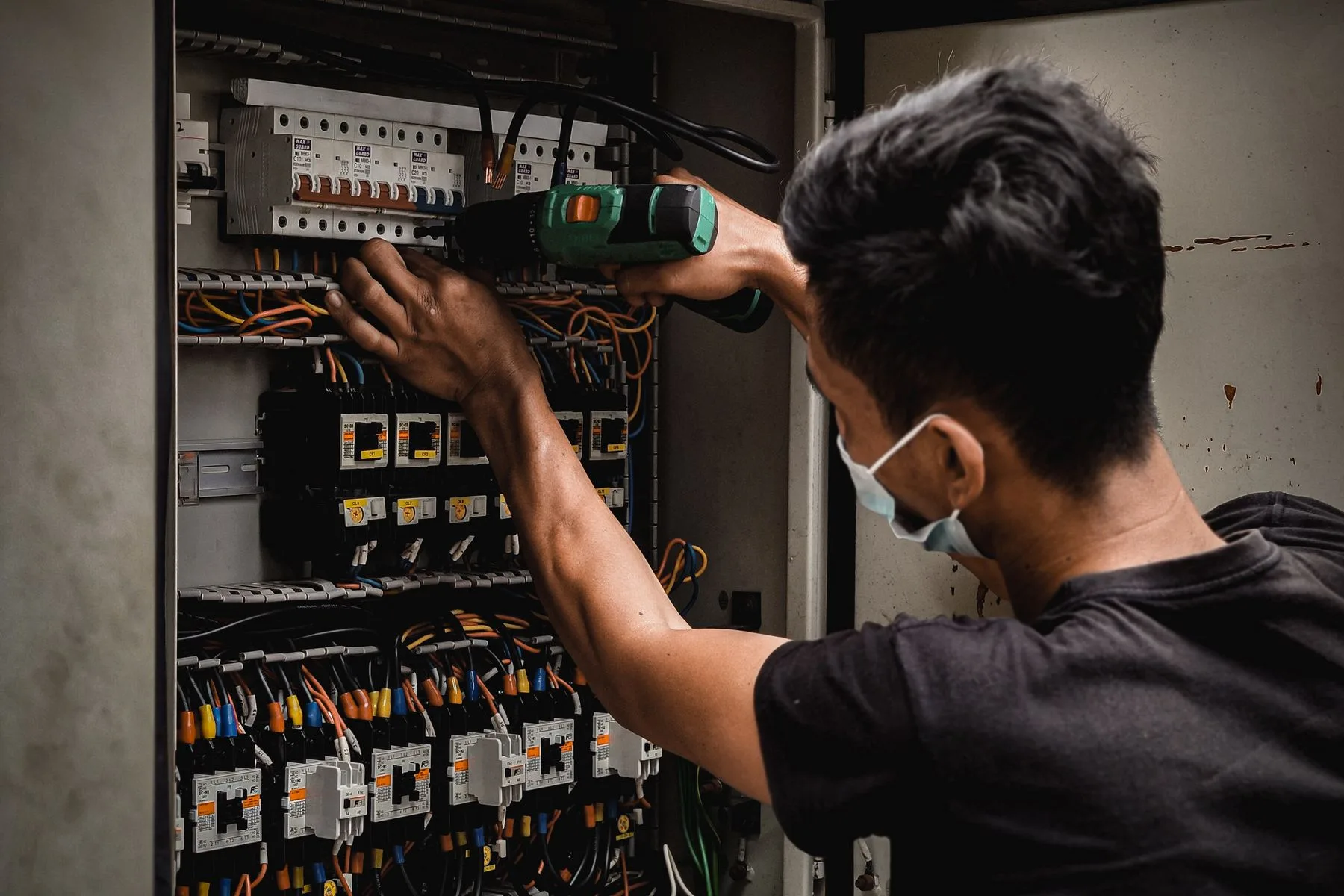 Electrical Contractor Funding 7 Electrician working on a circuit breaker panel