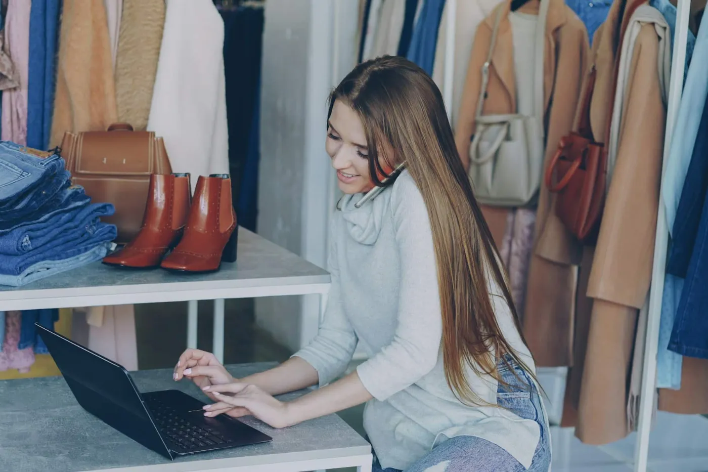 Small Business Loans | Funding for Your Business 2 Boutique owner completing a quick online funding application on her laptop