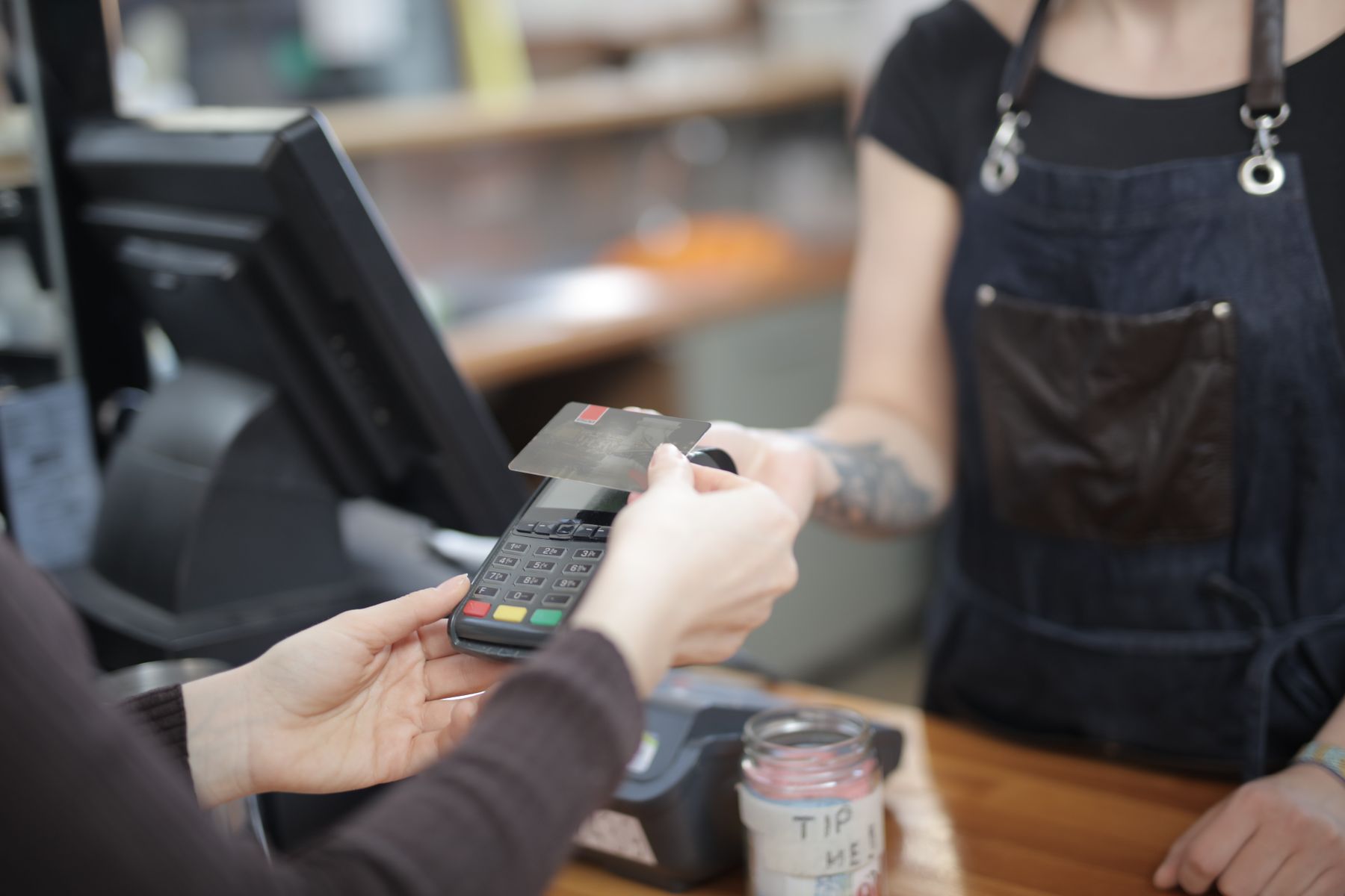 Revenue-Based Financing vs. Merchant Cash Advances: What's Different? 2 Customer paying by card at a small shop counter