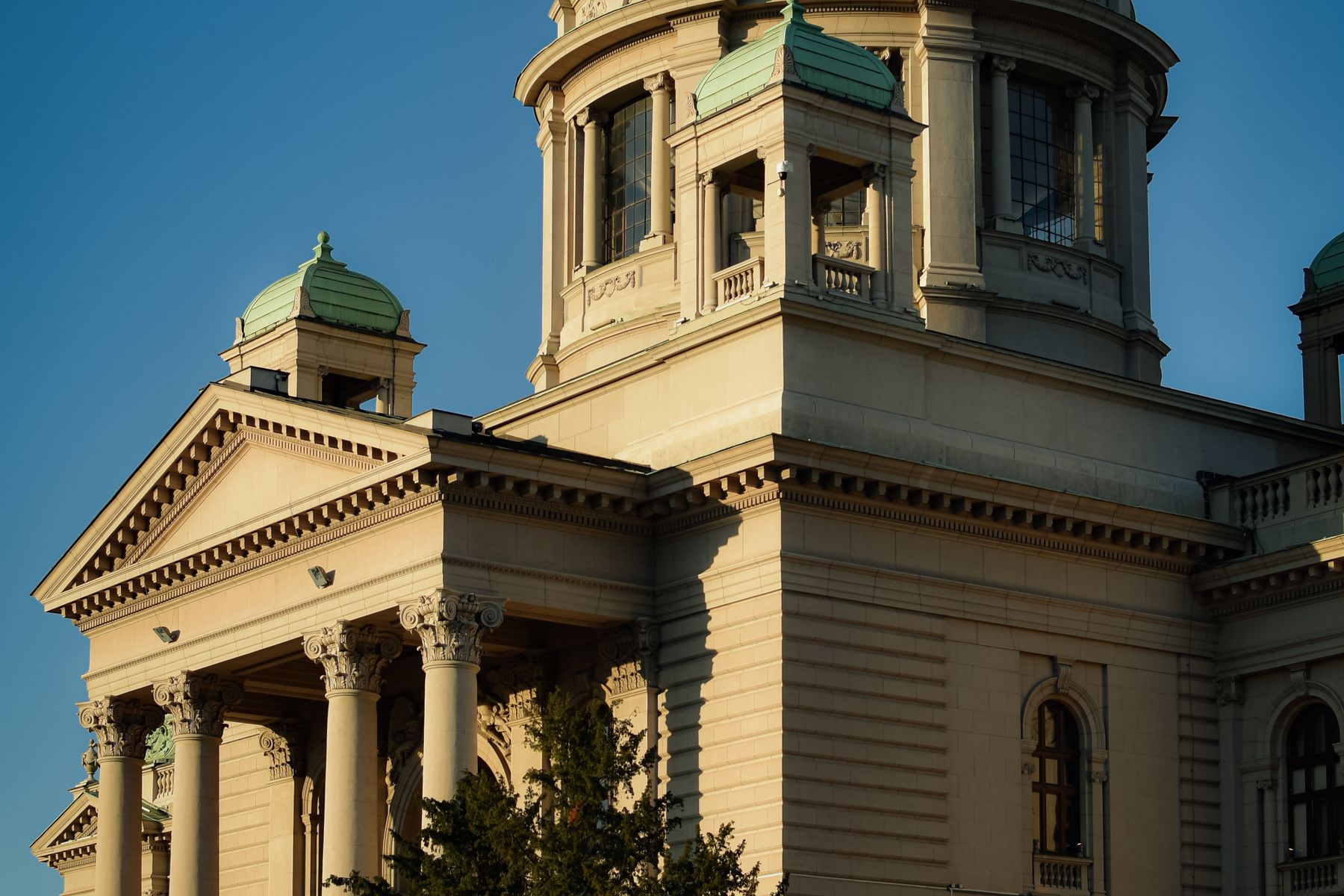 Revenue-Based Financing vs. Traditional Business Loans: Which Is Right for You? 2 Stone bank building beside a modern storefront