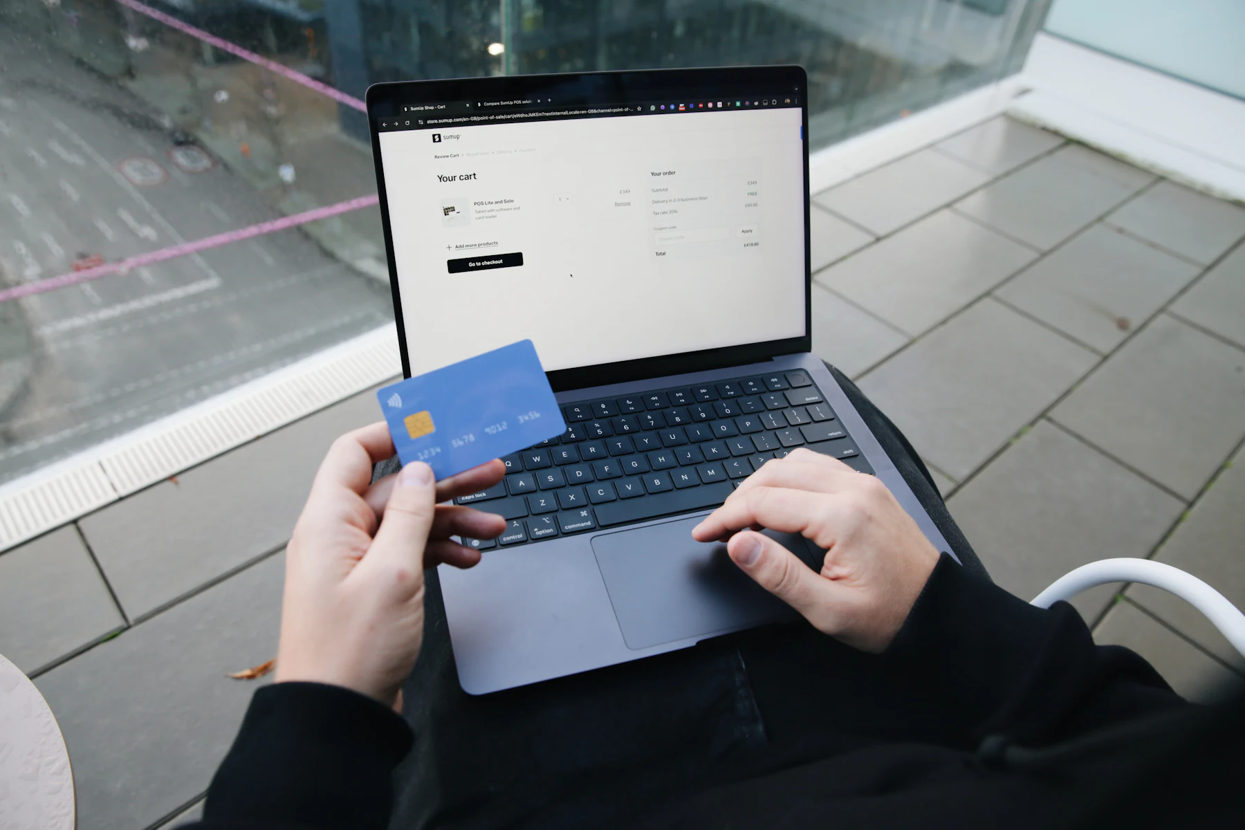 Same-Day Approval vs. Same-Day Funding: The Difference 2 Person holding a bank card while using a laptop